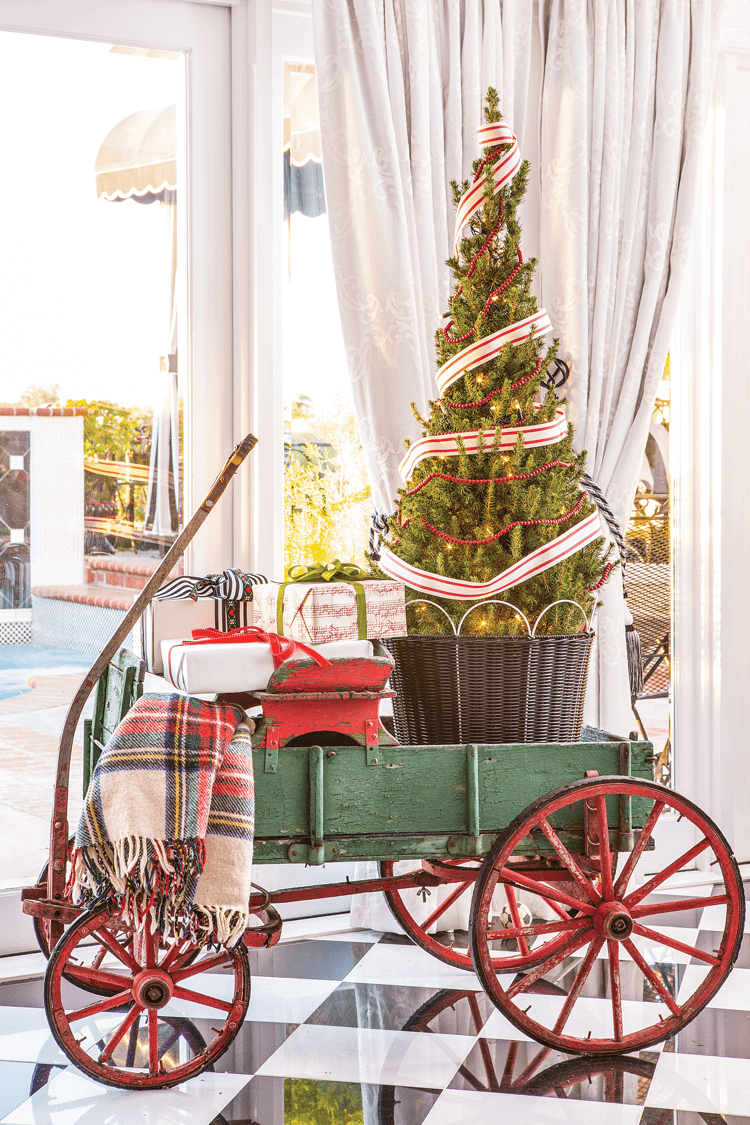 JANICE’S FATHER’S ANTIQUE WAGON with its red wheels and green paint is perfect for the holidays!
