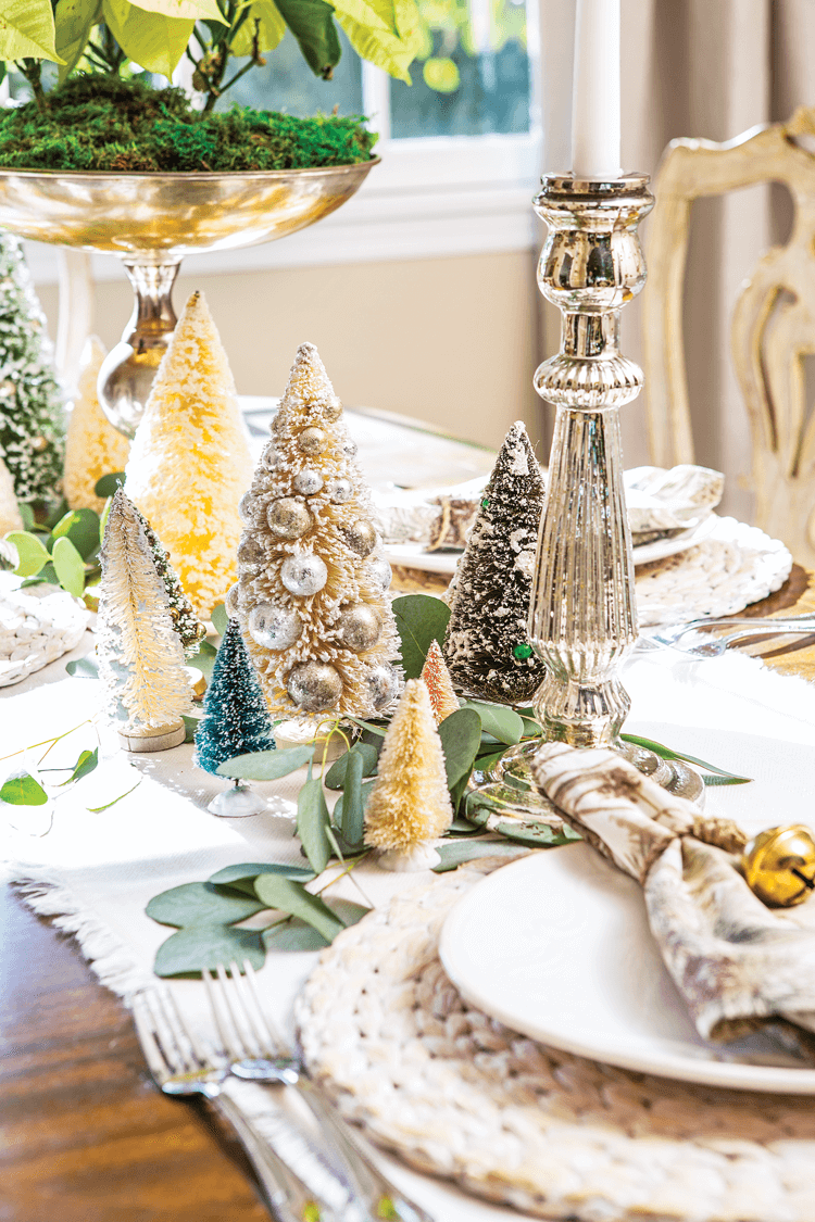 Vintage bottle brush trees and candlesticks add a touch of metallic to Maison de Cinq's neutral and natural christmas decor tablescape