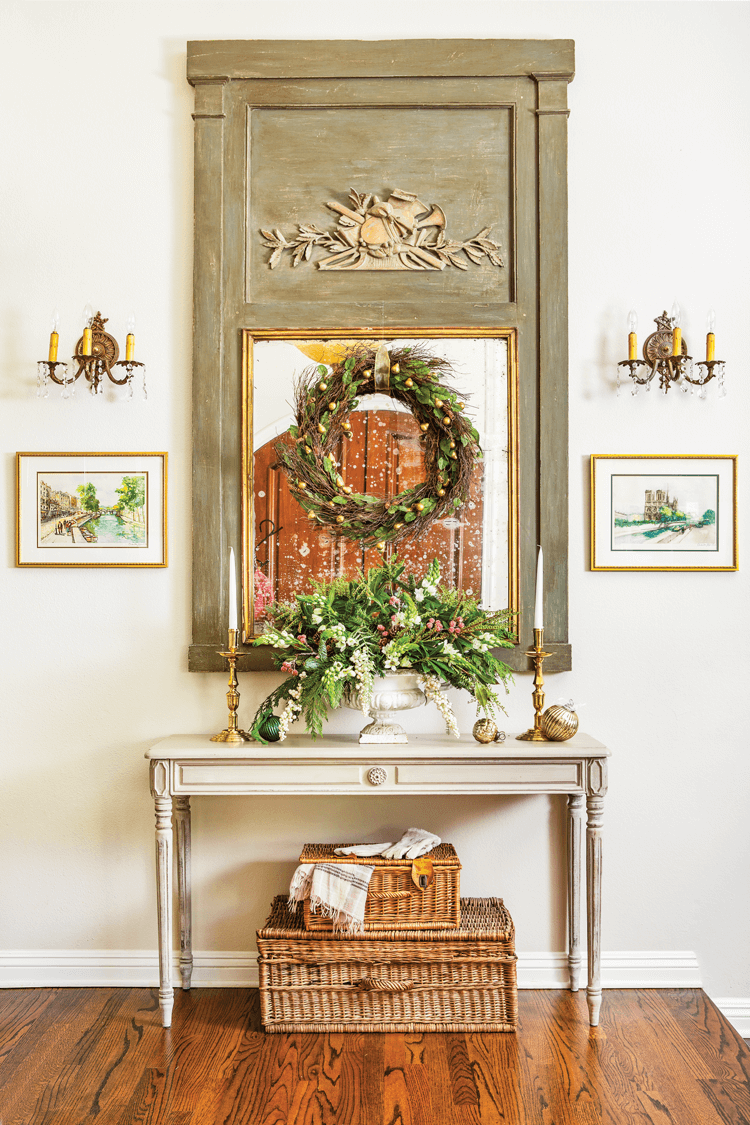 A modern French country entryway decorated with neutral and natural christmas decor