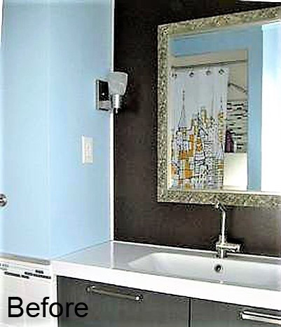 bathroom vanity prior to the renovation, with white countertop and basic hardware.