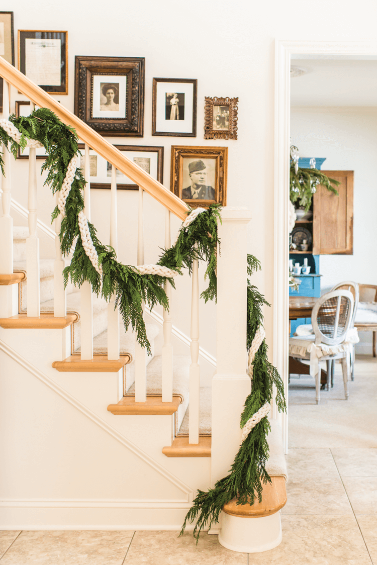 A natural garland of fresh greenery decorates Miss Mustard Seed's staircase.