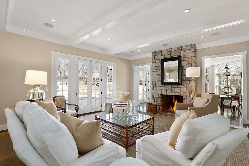 The stand-out fireplace with a floor-to-ceiling stone structure as seen in this past Yankee Barn Homes build. The Project House will boast two amazing fireplaces in the open plan great room.