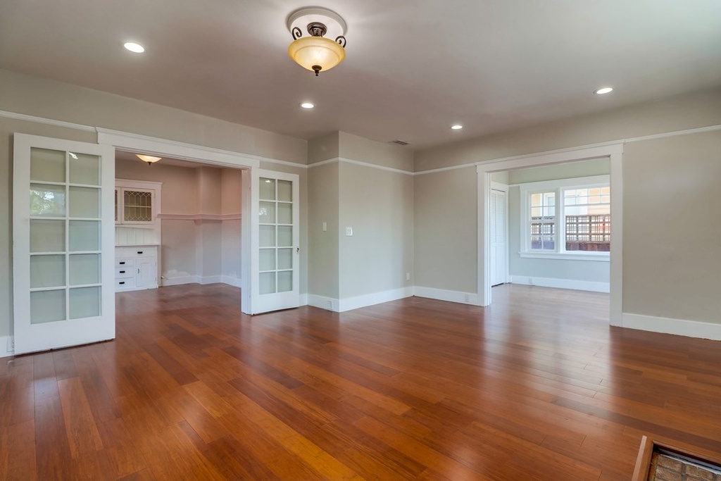 Spacious living room of a San Diego cottage with laminate hardwood floors.