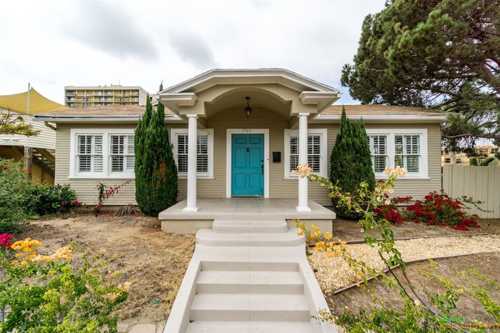 Exterior of a San Diego cottage with bright turquoise door