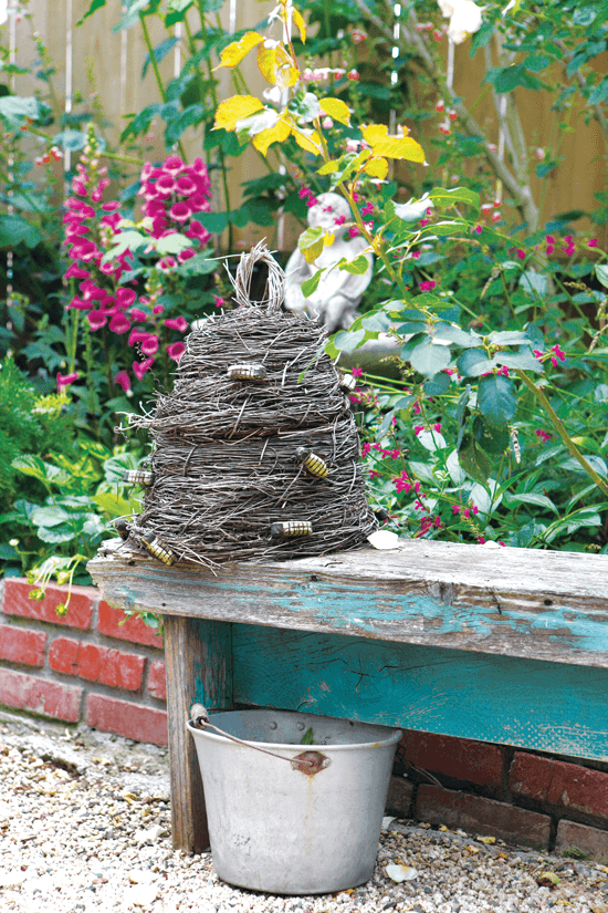 antique bee keep on a chippy painted bench