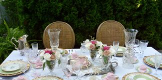 romantic table setting with gold cane chairs, roses and limoge china