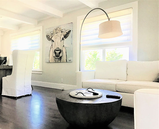 white modern sofas with cow art