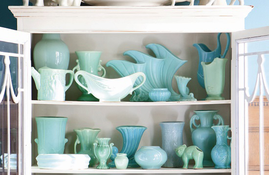 turquoise pottery in a white china cabinet