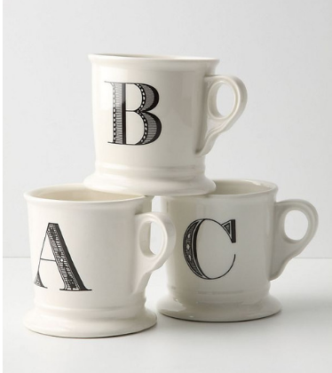 Stack of three white mugs each monogrammed with A, B and C