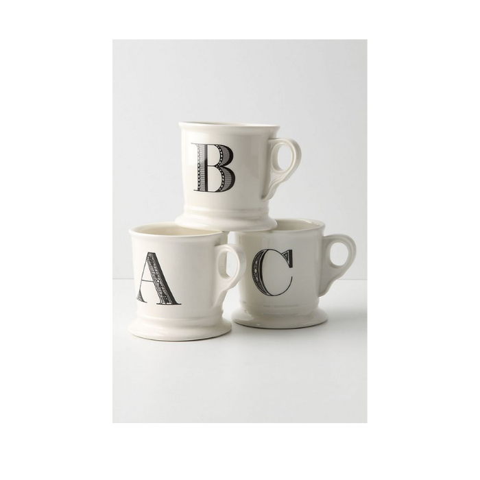 Stack of three white mugs each monogrammed with A, B and C