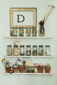 Shelves with mason jars filled with crafting supplies.