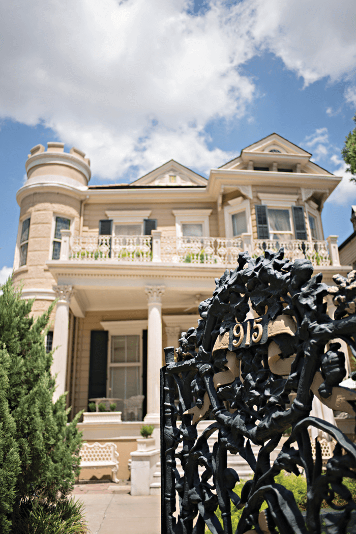 Black rod iron gate opening to the walkway up to the Cornstalk Hotel. 