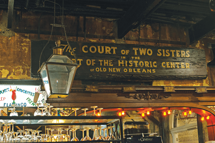 Entryway and storefront of the The Two Court Sisters restaurant. 