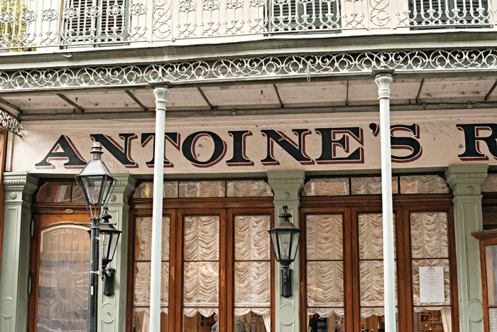 New Orleans street front signage of Antoine's restaurant.