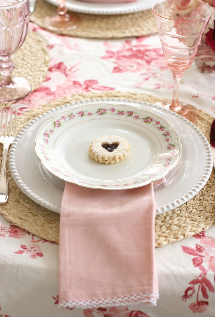 heart jam cookie on a pink and red galentines tablescape