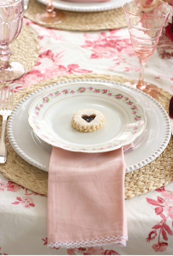 heart jam cookie on a pink and red galentines tablescape