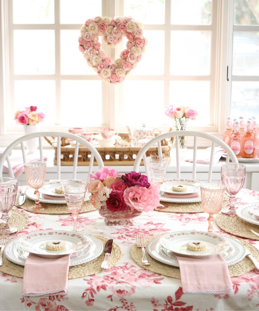 garden roses in a pink glass vase for pink and red galentines tablescape