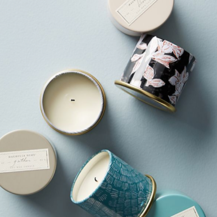 Multi- colored tins, opened with candle inside