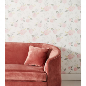 Blush velvet couch and floral wallpaper on the backdrop