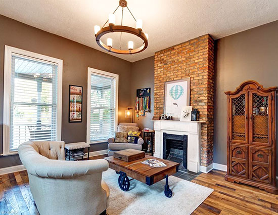 A beautiful brick fireplace and high ceilings make this a real gem. 