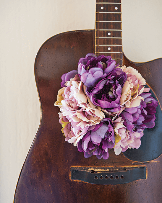 Vintage guitar decorated with purple flowers