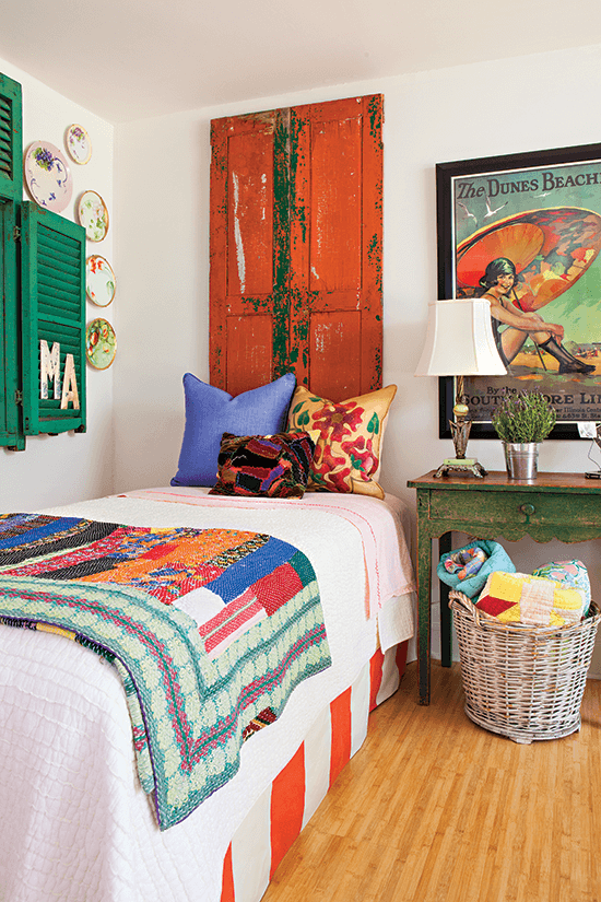 vintage bedroom with red shutter and colorful quilt