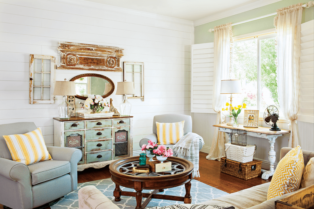 Cozy living room with window light comfy chairs and vintage coffee table.