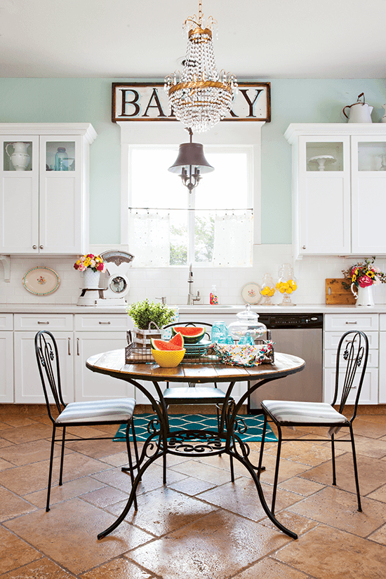 French bistro set in the kitchen, centered by the window in place of an island. 