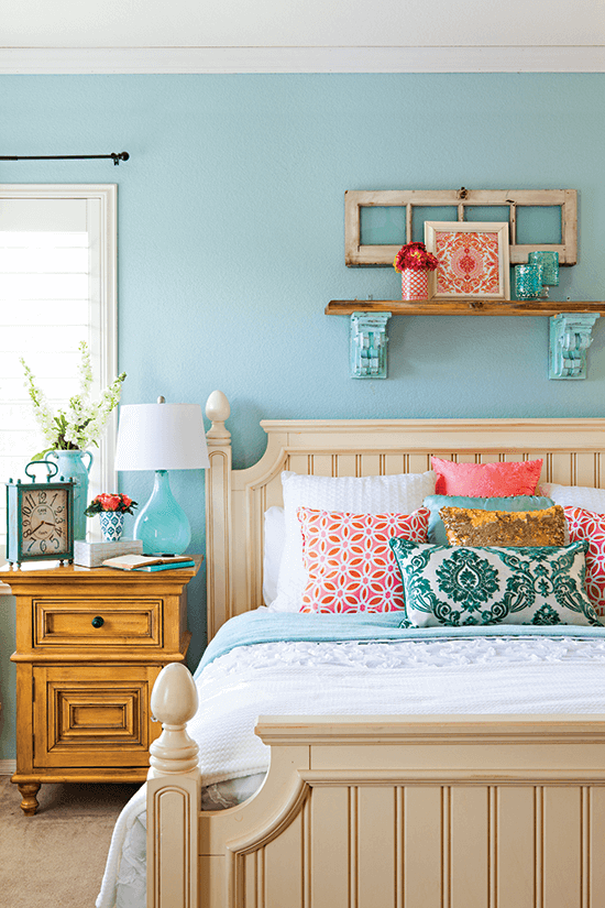 Bright and colorful bedroom with robin's egg blue walls and coral accents. 