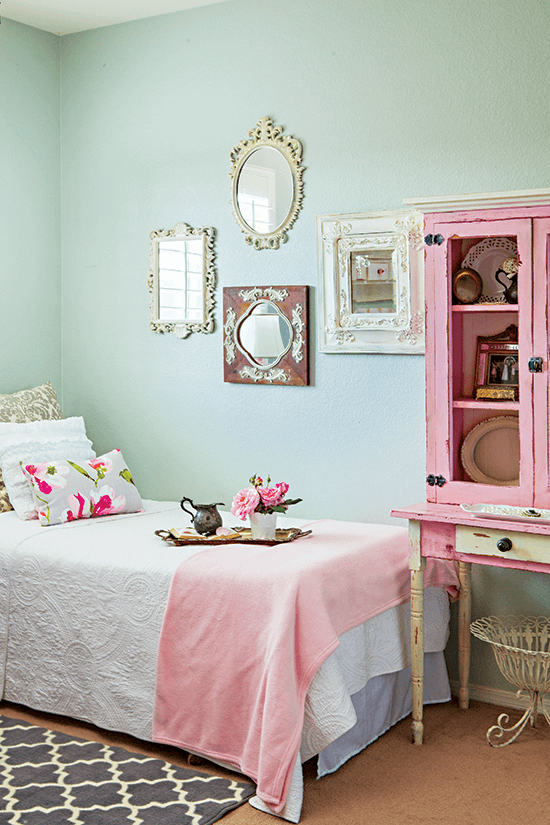 Charming light minty green walls with pink and cream accents and refurbished display cabinet. 