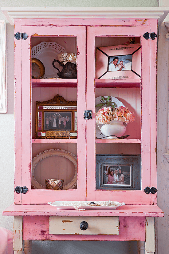 The pink cupboard was a thrift-store purchase for the wedding, which now houses ironstone and milk glass.