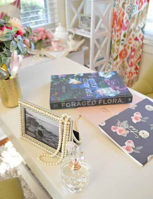 foraged flora book and pearls on a desktop