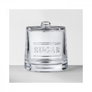 Clear glass sugar bowl with lid and "sugar" written across the front in all caps.