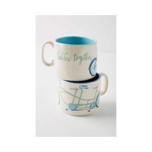 Two coffee mugs stacked on top of each other, "better together" written on one and a tandem bicycle on the other.