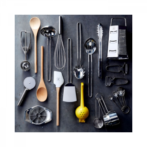 An array of kitchen tools laid flat so that you can see all 18 pieces such as grater, wooden spoon, whisk, tongs, etc.