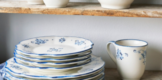 White dishes with cobalt blue floral accents laid out on rustic wood