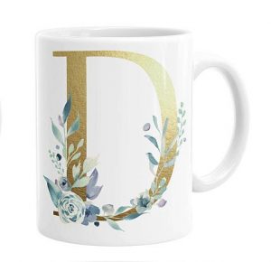 white mug with gold letter D and green painted leaves