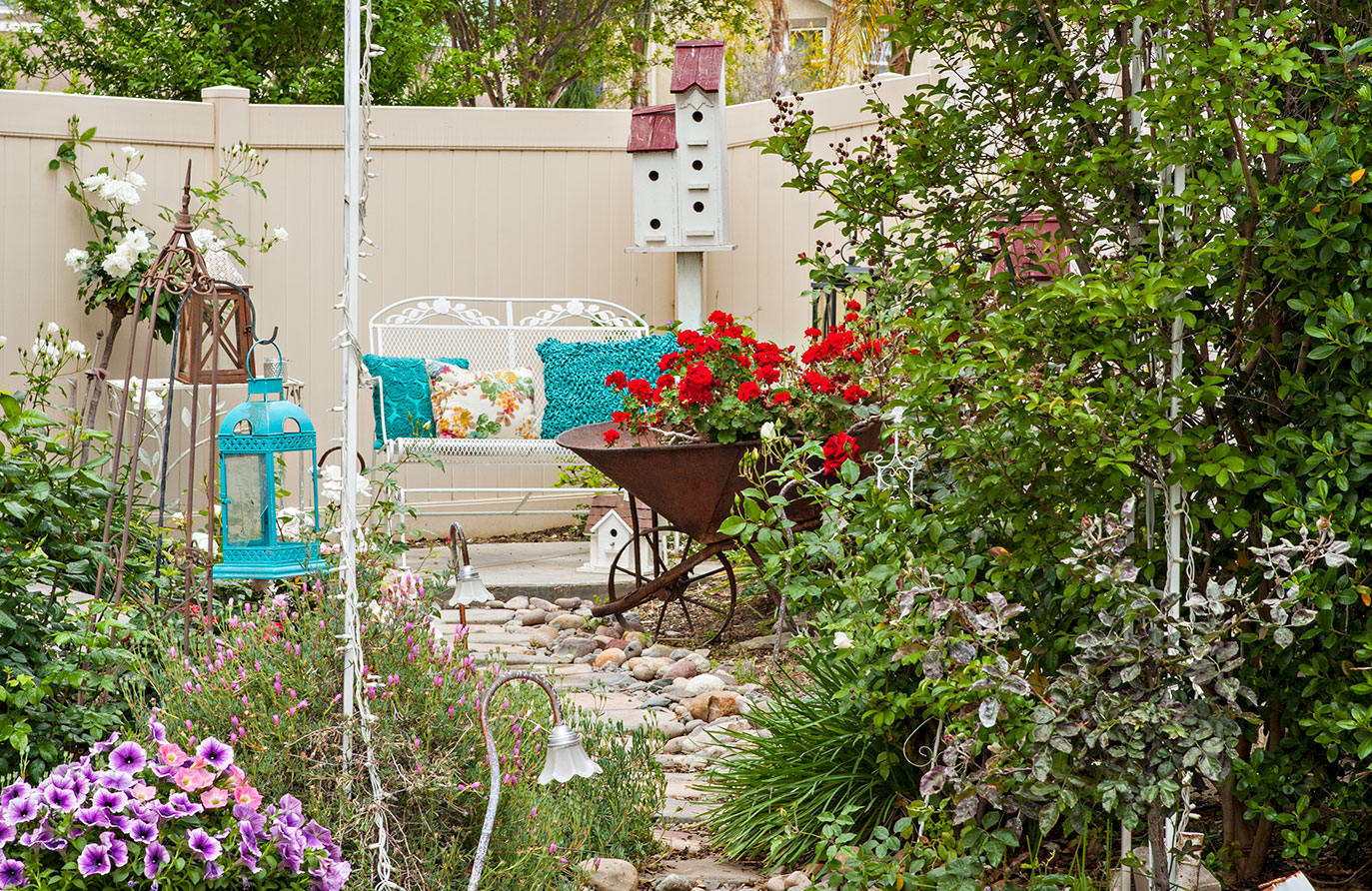 vintage patio set and wheelbarrow used as a planter