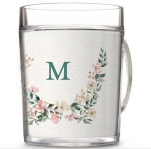 clear glass mug with monogram surrounded by a floral half wreath