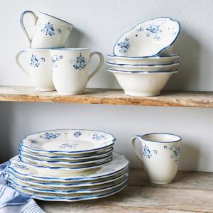 White dishes with cobalt blue floral accents laid out on rustic wood