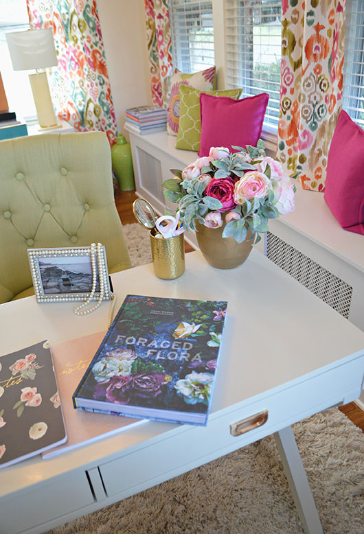 white desk with flower arrangement