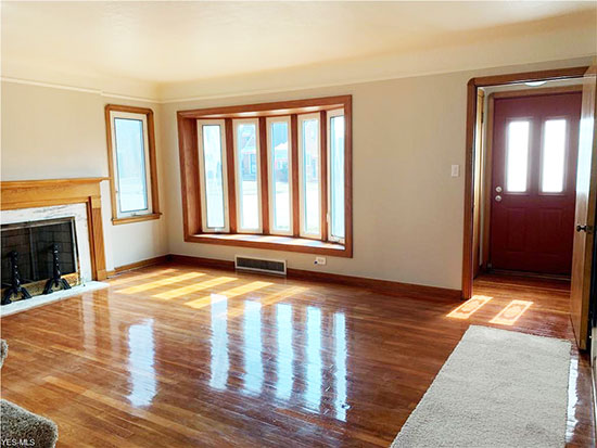 wood floor living room with bay window