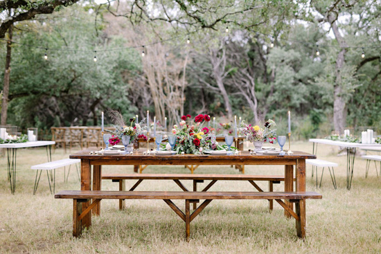 outdoor picnic table with floral table setting and candles