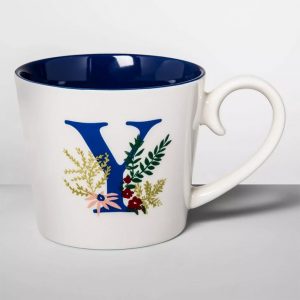 y monogram mug with a blue interior and a leafy spray design