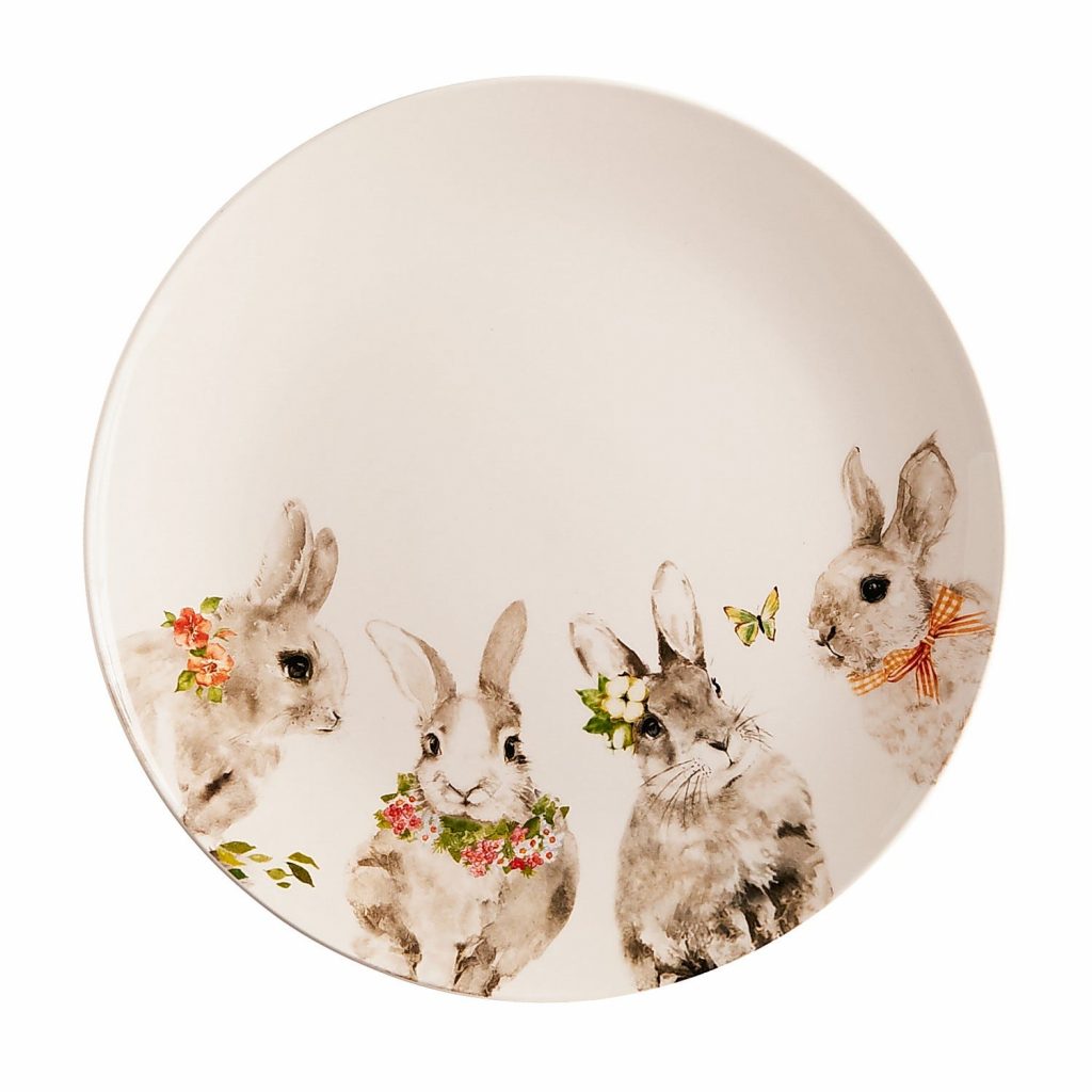 White plate with gray and white painted bunnies around the bottom half of the plate.