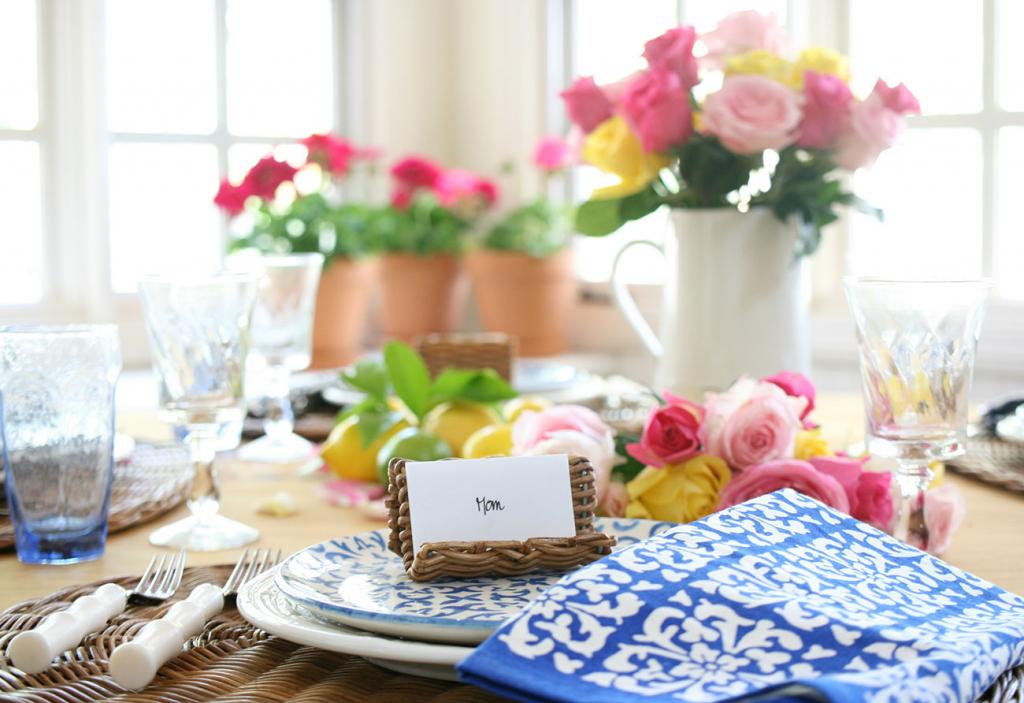 blue and white napkins and a wicker place card setting