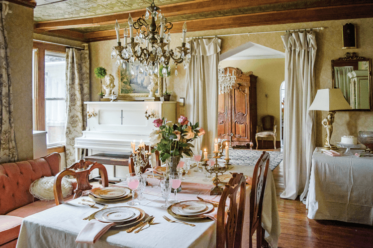romantic home filled with wooden antiques, chandeliers and a restored piano. 