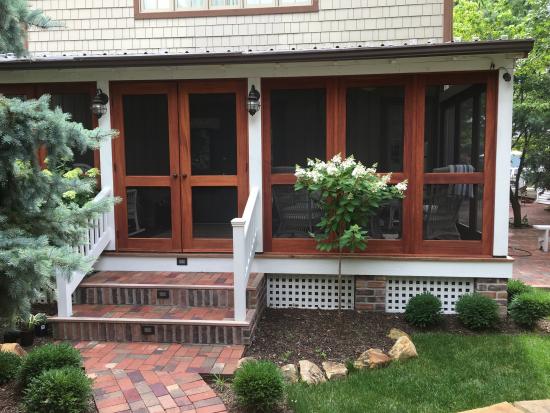 double gardenia screened-in porch front view // vintage doors