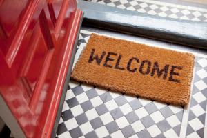 A doormat that says "welcome".