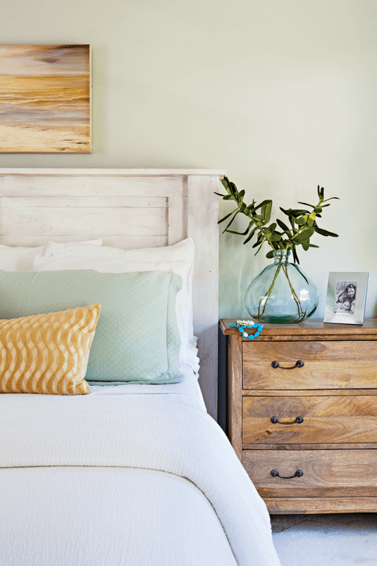 image if a light and beauty looking bed with a wooden nightstand next to it .